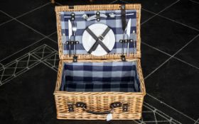 Wicker Picnic Basket with leather handle and straps, lined in blue checked fabric with two plates,