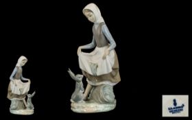 Lladro Figure of a Young Girl with a rabbit. Measures 9" tall.