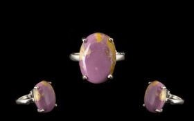 Phosphosiderite Solitaire Ring, an oval cabochon of the unusual mottled lilac and coffee coloured