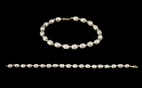 9ct Gold Pearl Set Bracelet with Gold Spacers - clasp marked 9.375. 7.5" inches - 18.