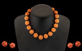 Pink Coral Coloured Bakelite Carved Bead Necklace 16" in length - together with a pair of earrings,