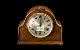 Oak Cased 1930s Shaped Top Mantle Clock with round steel face. Working condition.