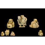 Three Carved Ivory Japanese Netsukes depicting a man with drum,