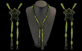 Art Deco Green Jade Bakelite Necklace of unusual form, with black inlaid designs. 40" length.