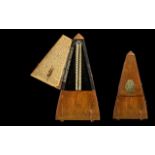 Swiss Made Wooden Metronome raised on four ball feet.
