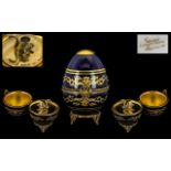 Limoges of France Faberge Egg No.446, in cobalt blue with gilt relief, lid lifts to reveal a swan.