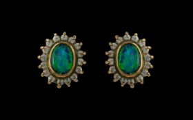 Pair of Opal Stud Earrings surrounded by CZ stones.