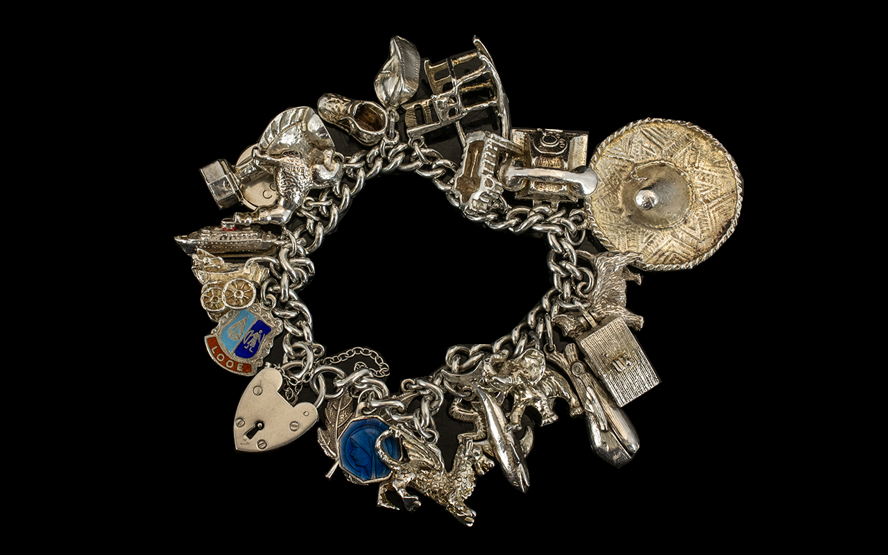 Vintage Nice Quality Silver Charm Bracelet loaded with over 20 good silver charms.