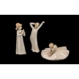 Lladro Figure of young girl playing an instrument, measures 8.5" tall.