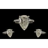 A Fine Quality Platinum and Iridium 8 Single Stone Diamond Set Dress Ring - the large pear shaped