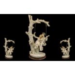 Large Resin Figure of a Couple on a Swing depicting a tree with a swing and a courting couple,