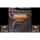 Piano Stool/Seat in mahogany with rattan seat. Curved wood base raised on four legs with stretcher.