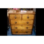 A Victorian Mahogany Chest of Drawers fitted with turned wood handles,