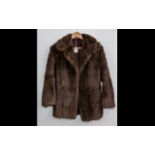 Ladies Fur Jacket. Collar and reveres, two slit pockets, half belt to back. Fully lined in brown