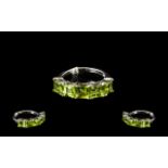 Peridot Band Ring, five square cut peridots, totalling 3.25cts, set closely, across the finger, in