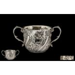 Antique Period Twin Handle Embossed Silver Cup of pleasing proportions.