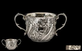 Antique Period Twin Handle Embossed Silver Cup of pleasing proportions.