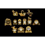 A Collection of Good Quality Gold Gilt & Brass Miniature Clocks. Twelve in total, all of solid
