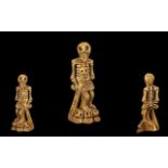 Carved Bone Skeleton figure holding a sword, with skulls at his feet. 3" high. Please see images.