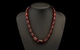 Cherry Amber Coloured Barrel Bead Necklace In Graduating Form. 18 Inches In length.