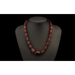 Cherry Amber Coloured Barrel Bead Necklace In Graduating Form. 18 Inches In length.