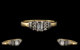 18ct Gold Diamond Ring set with a central fancy cut diamond set between six round brilliant cuts.