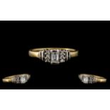 18ct Gold Diamond Ring set with a central fancy cut diamond set between six round brilliant cuts.