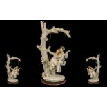 Large Resin Figure of a Couple on a Swing depicting a tree with a swing and a courting couple, the