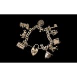 Silver Curb Bracelet Loaded with Eight Good Quality Vintage Silver Charms.