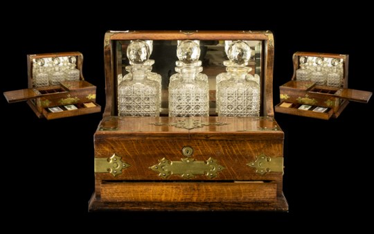 Fine Quality Oak Cased Antique Tantalus Compendium with mirror back and brass carrying handles