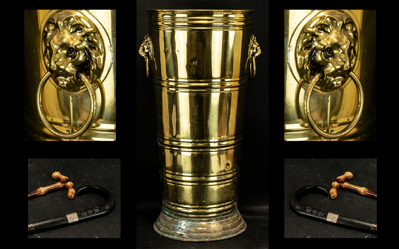Large Vintage Brass Umbrella Stand with a lion's head either side holding a ring in the mouth.
