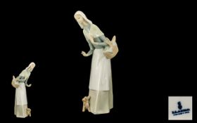 Lladro - Porcelain Figure ' Girl with Basket ' Model No 1034. Issued 1969 - 1991. Height 12 Inches.