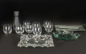 A Modern Carafe and Eight Glasses Set plus 3 glass serving dishes.