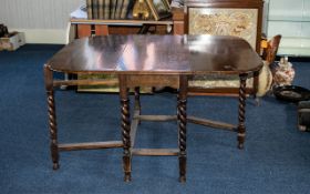 Large 1920's Oak Barley Twist Leg, Drop Leaf Table of Typical Form with Stretchers.