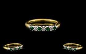 18ct Gold - Attractive Seven Stone Emerald and Diamond Ring. Full Hallmark for 750 - 18 ct.