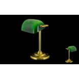 A Brass Desk/Bankers Lamp with green polished shade raised on a circular base.