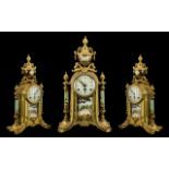 A French Empire-Style Mantle Clock with brass case with painted supports and urn finial.