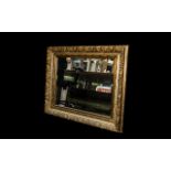 Large Gilt Framed Mirror with Bevelled Edge, The Frame with a Molded Floral Motifs Swept.