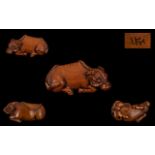 A Japanese Carved Boxwood Netsuke, In The Form of a Water Buffalo,