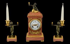 French Clock Garniture. A pink marble and ormolu mounted clock garniture.