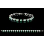 A Modern Silver Tennis Bracelet - Comprising 19 Oval Cabochon Opals.