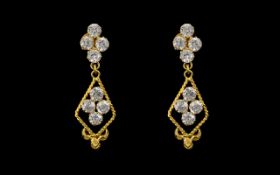 A Pair of Indian Gold Drop Earrings set with white faceted stones, screw backs.