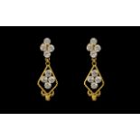 A Pair of Indian Gold Drop Earrings set with white faceted stones, screw backs.