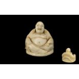 Carved Ivory Figure of a Seated Buddha; 1.75 inches (4.5cms) in diameter x 1.75 inches (4.