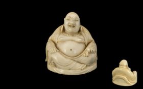 Carved Ivory Figure of a Seated Buddha; 1.75 inches (4.5cms) in diameter x 1.75 inches (4.