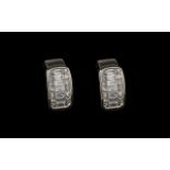 A Superb Pair of Diamond Earrings Set In Platinum. The Baguette Cut and Princes Cut Diamonds of