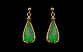 A Pair of 9ct Gold Opal Drop Earrings of triangular form. The opals approximately 14 by 7mm.