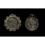 Two American Silver Dollars in Pendant Mounts dated 1883 and 1922.