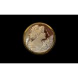 A Signed Round Shaped 9ct Gold Mounted Shell Cameo, Depicting a Young Woman Holding Flowers.