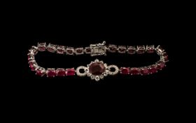 Ruby Line Bracelet with Central Infinity Motif, 23cts, a line of oval cut rubies with a solitaire,